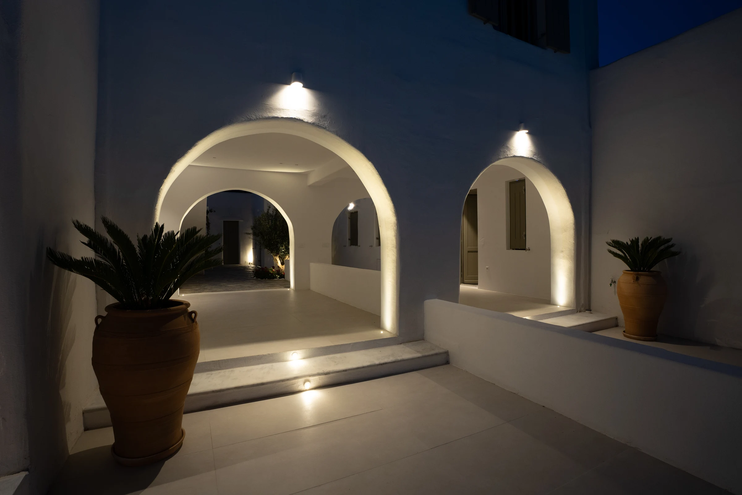 A softly illuminated Cycladic archway at the villa after dark
