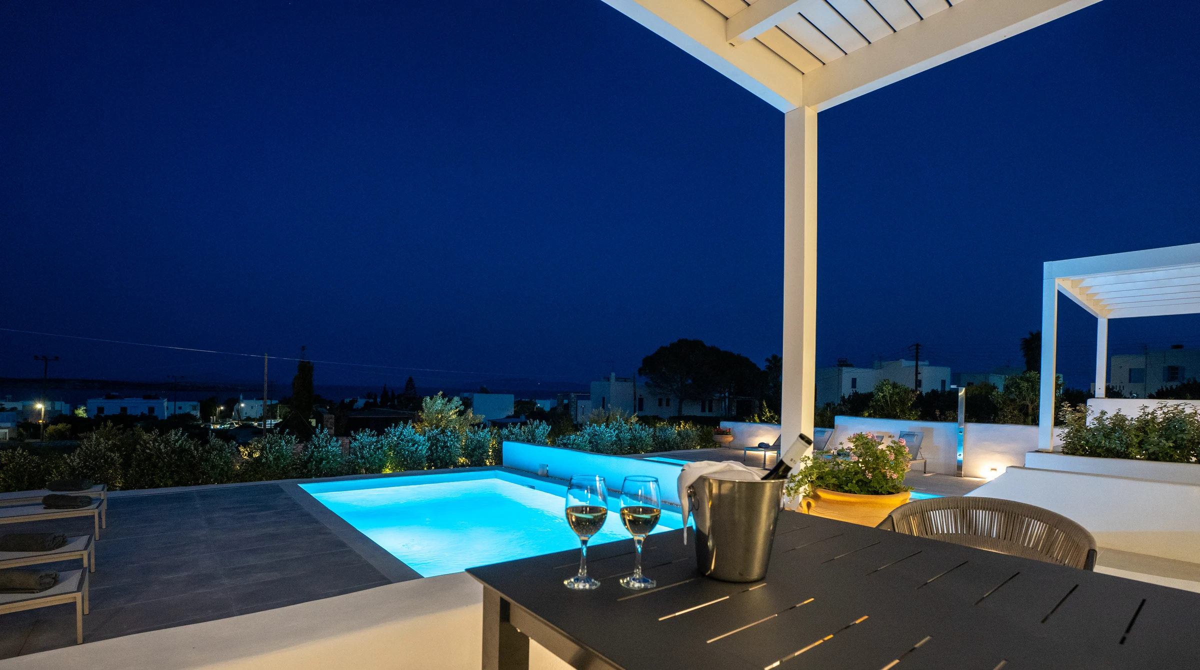 The villa's illuminated pool and terrace at night